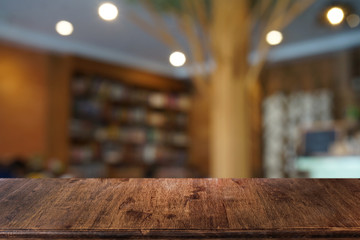 Empty dark wooden table in front of abstract blurred bokeh background of restaurant . can be used for display or montage your products.Mock up for space.