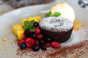 Delicious and beautiful dessert of .Chocolate cake with summer berries,mango.
