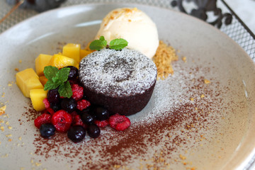 Delicious and beautiful dessert of .Chocolate cake with summer berries,mango.