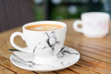 hot coffee on table / hot cappuccino with nice pattern milk foam 