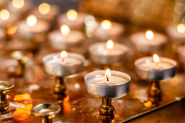 Burning candles on the golden stand