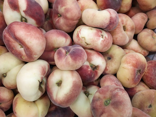 fig peach, flat peaches. delicious juicy ripe fig peaches background. fresh tasty peaches fruit at farmers. red mature fig peaches background texture, agricultural products, sale in market. Harvest.
