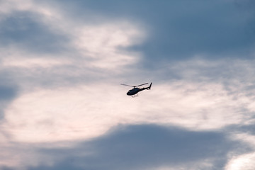 Fototapeta na wymiar Helicopter flying in the sky during sunset in Dehradun, Uttarakhand, India