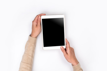 Closeup shot of  Woman's hands with perfect manicure  holding tablet, Empty display device. with clipping path.