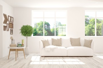 Stylish room in white color with sofa and summer landscape in window. Scandinavian interior design. 3D illustration