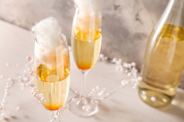 Glasses with tasty cotton candy cocktail on table