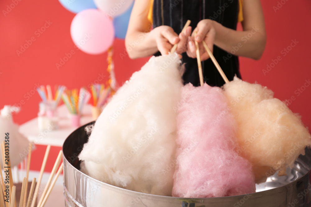 Wall mural Woman making cotton candy at fair