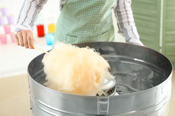 Woman making cotton candy at fair