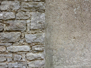 Restored old stone wall in contrast new and old gray background  