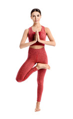 Sporty woman practicing yoga on white background