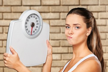 Beautiful young s woman holding scales
