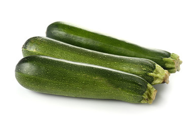 Fresh zucchini squashes on white background