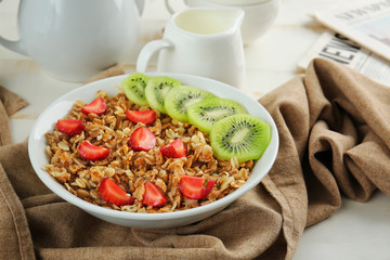 Bowl with tasty sweet oatmeal on table