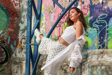 Young beautiful lady wearing a stylish white top.Portrait shooting of a stylish girl.Trends summer 2019.