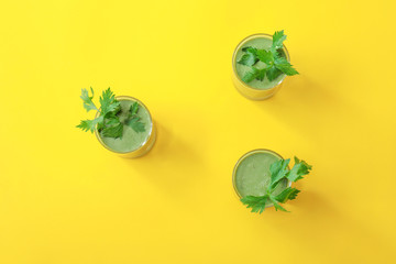 Glasses of healthy smoothie on color background