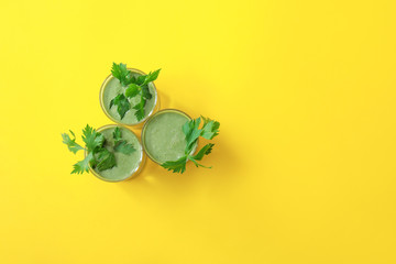 Glasses of healthy smoothie on color background