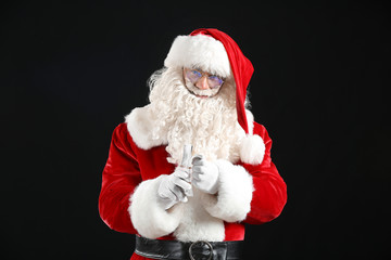 Santa Claus with money on dark background