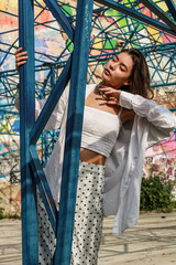 Young beautiful lady wearing a stylish white top.Portrait shooting of a stylish girl.Trends summer 2019.