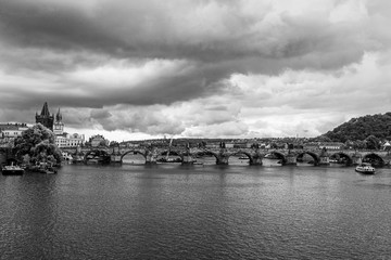 prague charles bridge view from moldova river in b&w
