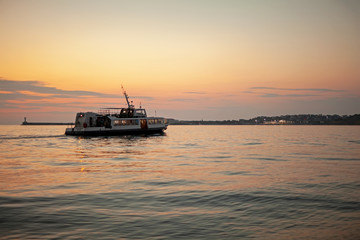 Fototapeta na wymiar Ship against the sunset sky in the sea.