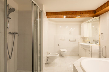 Fototapeta na wymiar Bathroom with white tiles and wooden ceiling
