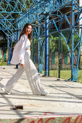 Young beautiful lady wearing a stylish white top.Portrait shooting of a stylish girl.Trends summer...