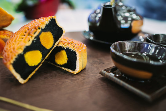 Beautiful Moon cakes and teacup on wooden table. Mid autumn festival Mooncake in Vietnam. Royalty high quality free stock image.