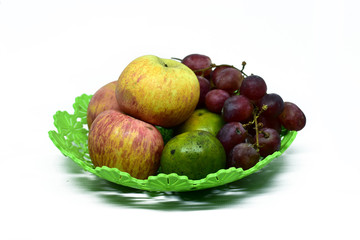 Fresh juicy fruits on the plastic tray, isolated on white background