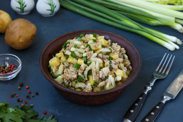 Salad with potatoes, mackerel and celery, seasoned with mustard and olive oil, horizontal photo