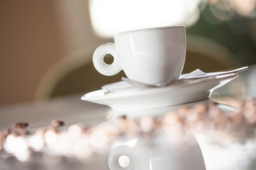 A cup of coffee on a white table in a coffee house