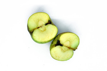 green apple cut into two parts. Isolated on white background