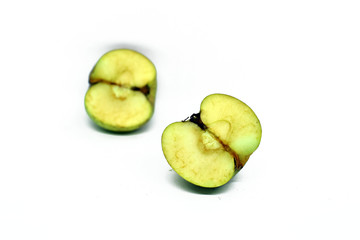 green apple cut into two parts. Isolated on white background