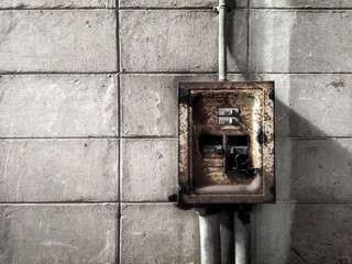 Old electric control box on the white wall of factory, Retro tone