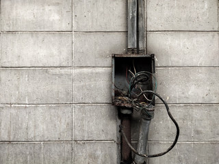 Old electric control box on the white wall of factory, Retro tone