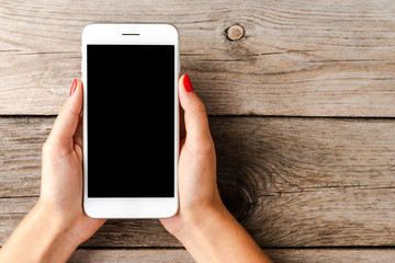 Woman using smartphone with empty black screen.