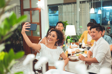 Group friends asian are taking selfies while eating dinner.