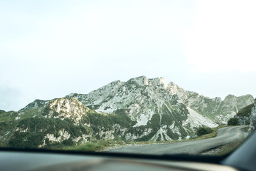 Beautiful view of the mountainous natural landscape in Montenegro. Mountain view through the glass of a car while traveling