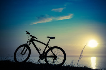 beautiful sunset on the sea and the silhouette of a bicycle
