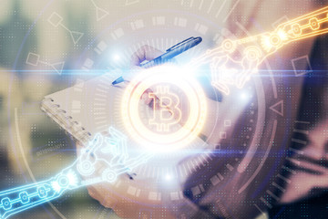 Cryptocurrency hologram over woman's hands writing background. Concept of blockchain. Double exposure