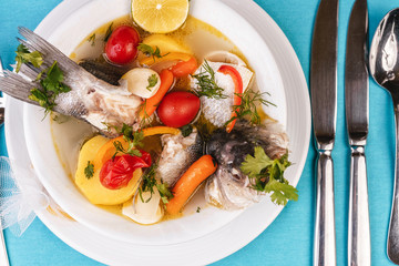 Mediterranean sea-fish soup with vegetables and lemon