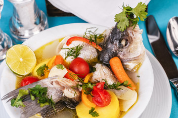 Mediterranean sea-fish soup with vegetables and lemon