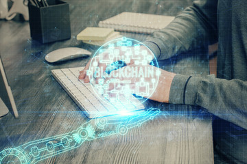 Blockchain theme hud with businessman working on computer on background. Concept of crypto chain. Double exposure.