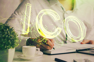 Man's hands working with notes background. Cryptocurrency and finance concept.