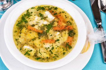 Mediterranean recipe for chicken, vegetables and seafood on a blue background