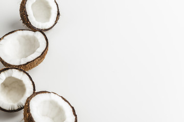 Ripe coconut pieces on white background, copy space