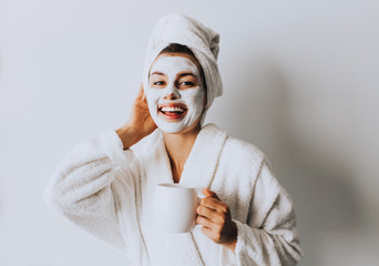 Beautiful Luxury Life. Breakfast. Happy Girl with a Cup of Coffee. Home Style Relaxation Woman Wearing Bathrobe and Towel after Shower. Spa Good Morning.Cosmetic procedure. Beauty spa and cosmetology.