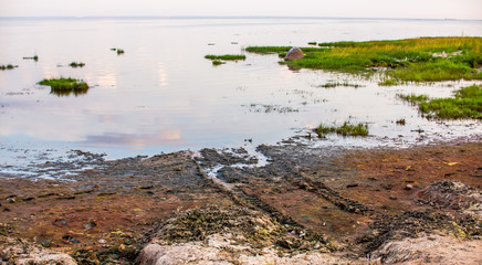 Sandy beach and sunset at the bay