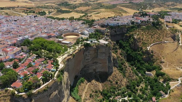 Aerial view of cityscape of Ronda, famous historic city and tourist attraction in Costa del Sol, corrida arena Bullring of the Royal Cavalry - landscape panorama of Andalusia from above, Spain, Europe
