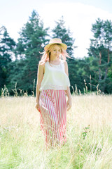 Young beautiful girl in the hat walking