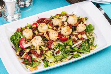 Mediterranean salad of radish, arugula, fried shrimp, chili peppers, cucumbers with olive oil